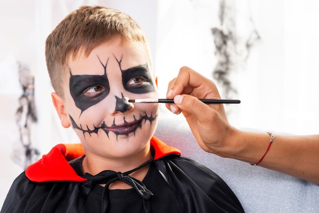 Cute young boy with halloween make-up