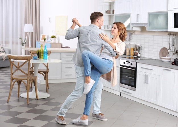 Cute young couple dancing at home