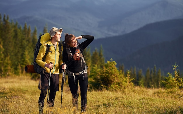 Cute young couple Majestic Carpathian Mountains Beautiful landscape of untouched nature