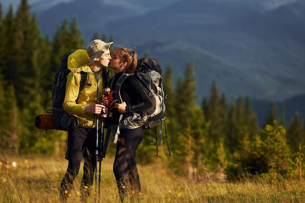 Cute young couple Majestic Carpathian Mountains Beautiful landscape of untouched nature