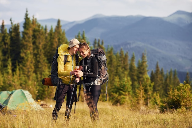 Cute young couple Majestic Carpathian Mountains Beautiful landscape of untouched nature