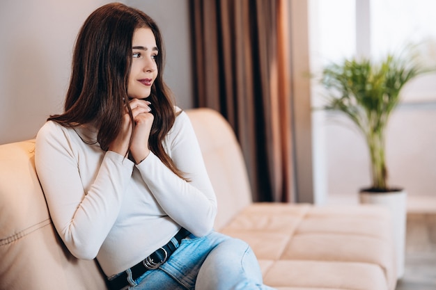 Cute young girl is wondering at home