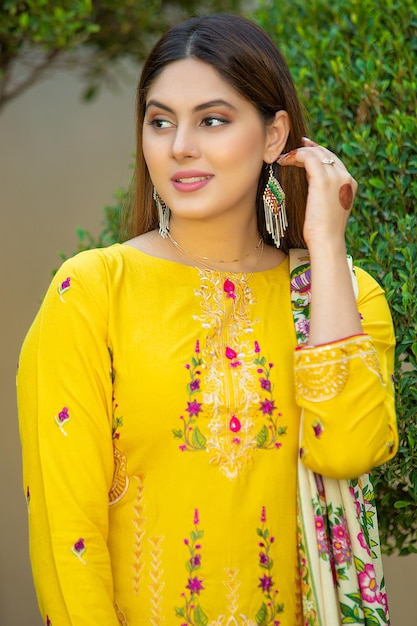 Cute Young Girl Portrait Wearing Yellow Dress in Garden