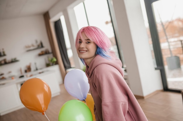 Cute young girl with colored hair looking happy