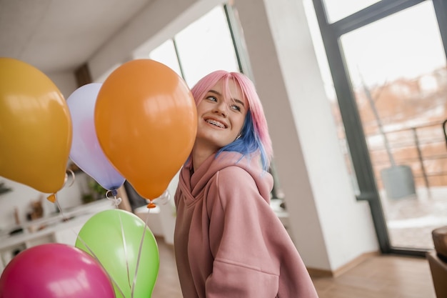 Cute young girl with colored hair looking happy