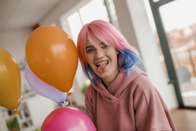 Cute young girl with colored hair looking happy