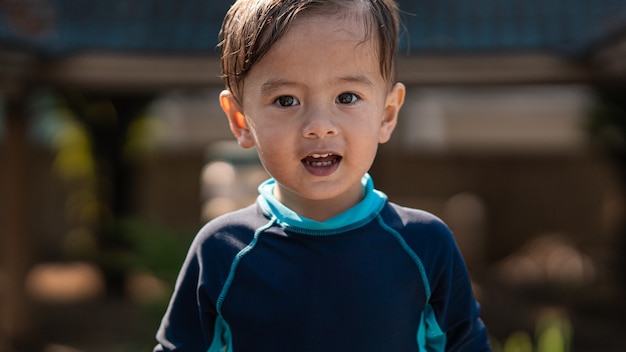 Cute young mixed race boy smiling in the sun