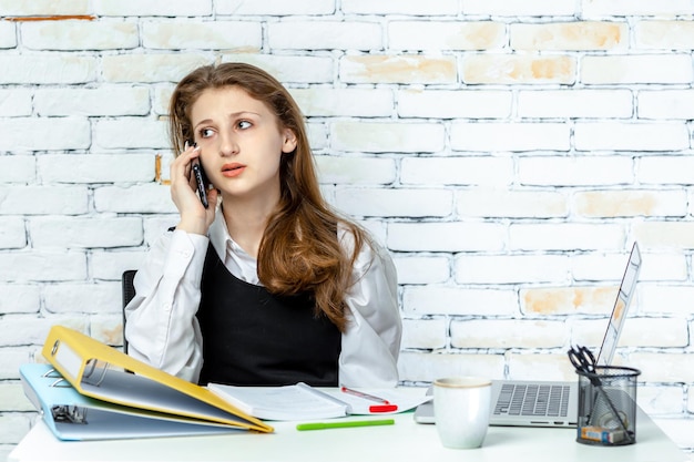 Cute young student stand on white background and talking on the phone High quality photo