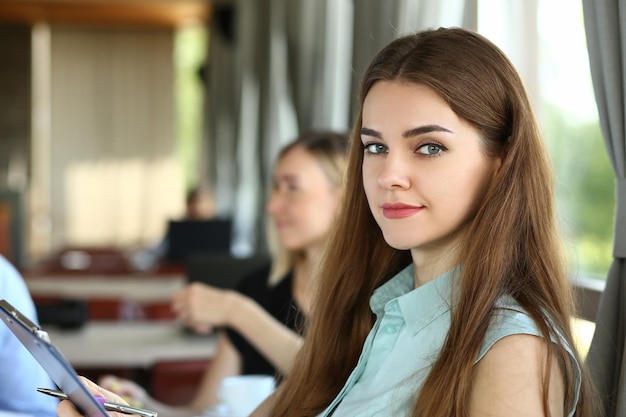 Cute young woman at business meeting in office