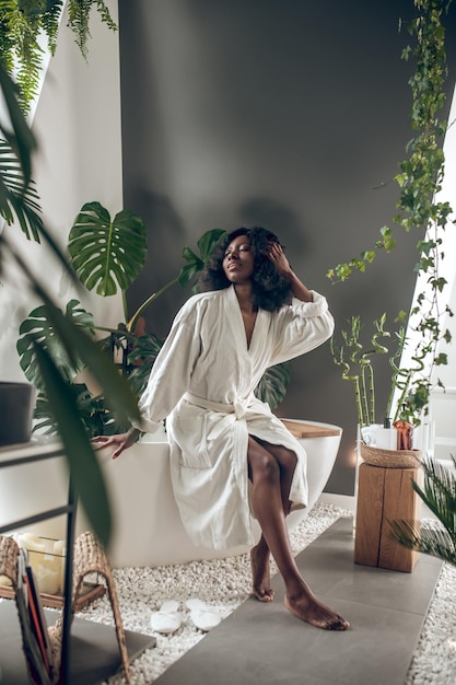 Cute young woman in a white bathrobe relaxing