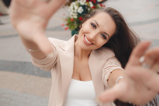 cute young woman with hands in camera outdoor