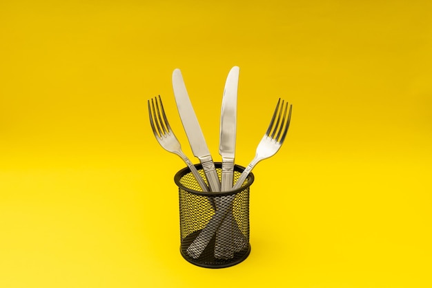 Cutlery lying on a yellow background minimalism