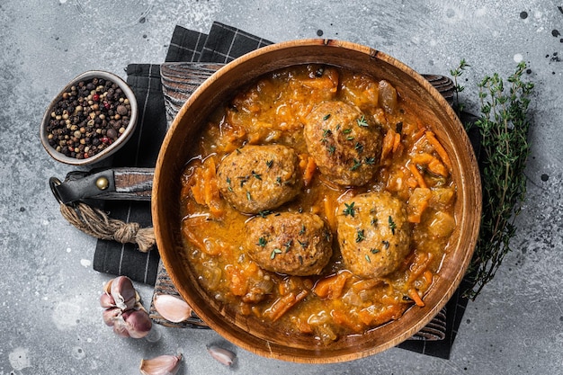 Cutlets or Fish balls with tuna in tomato sauce Gray background Top view