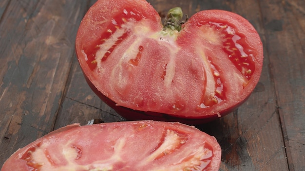 Cutting big ripe tomato in half