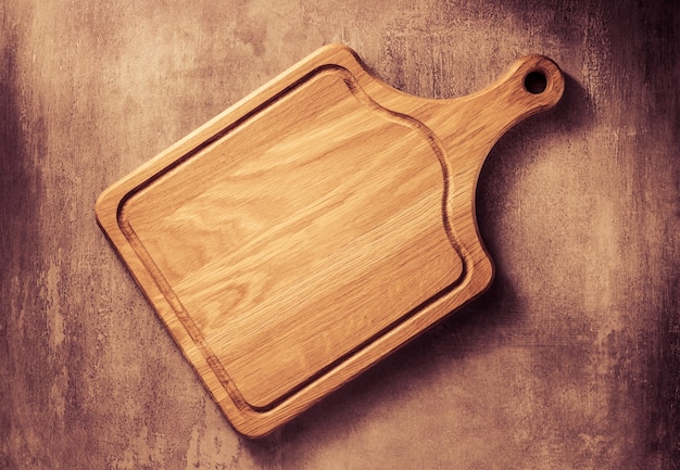 Cutting board at grey stone table background texture