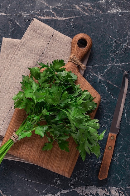 Cutting board parsley on a marble table