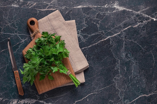 Cutting board parsley on a marble table