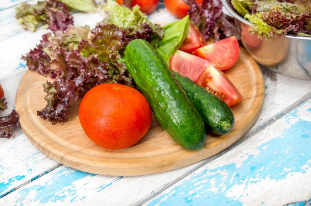 Cutting board with ingredients for salad on the table