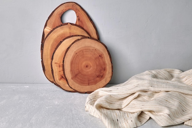 Cutting boards and coasters on a gray concrete table with a kitchen towel Food display template