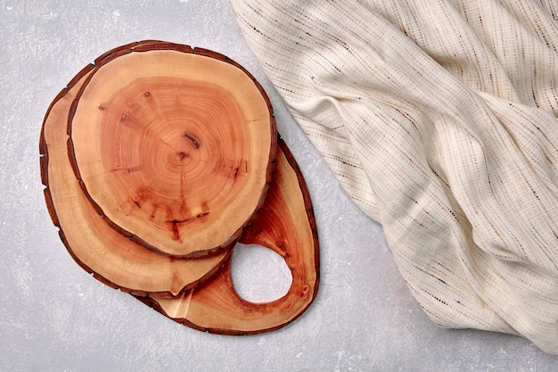 Cutting boards and coasters on a gray concrete table with a kitchen towel