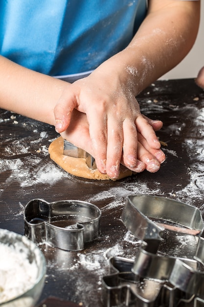 Cutting dough on different shapes. Christmas  gingerbread. 