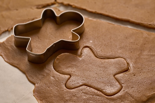 Cutting the dough with the gingerbread man mold.