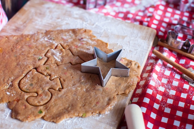 Cutting the gingerbread cookie dough for Christmas and New Year