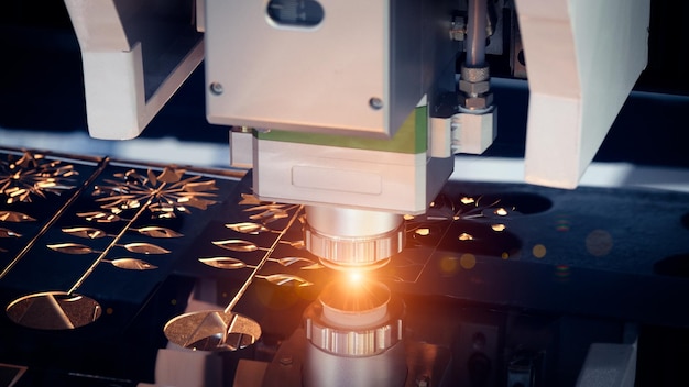 Cutting of metal with sparks fly from laser modern industrial technology concept