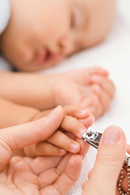 Cutting nails of a sleeping baby. selective focus