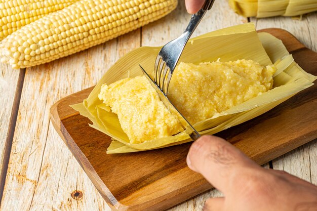 Cutting pamonha traditional brazilian food based in corn