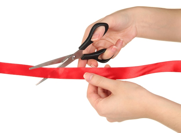 Cutting red ribbon isolated on white