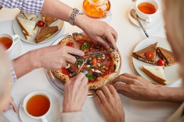 Cutting small pizza for friends