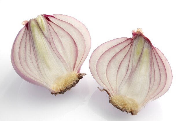 Cutting of small red shallot on white background