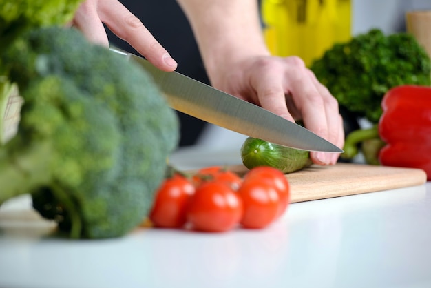 Cutting vegetables in the kitchen for salad.