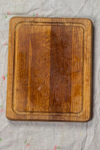 Cutting wood board on a gray background vertically