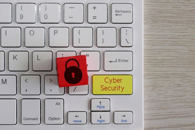 Cyber security concept Red wooden cube with padlock icon on keyboard with text Cyber Security