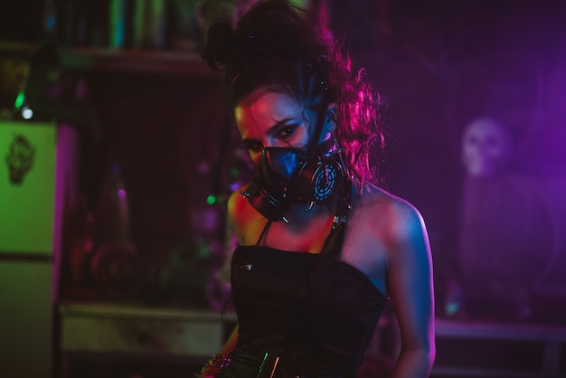 Cyberpunk cosplay. A girl in a gas mask in a post-apocalyptic style with neon lighting. Steampunk costume and makeup