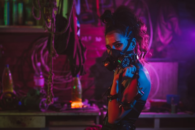 Cyberpunk cosplay. A girl in a gas mask in a post-apocalyptic style with neon lighting. Steampunk costume and makeup