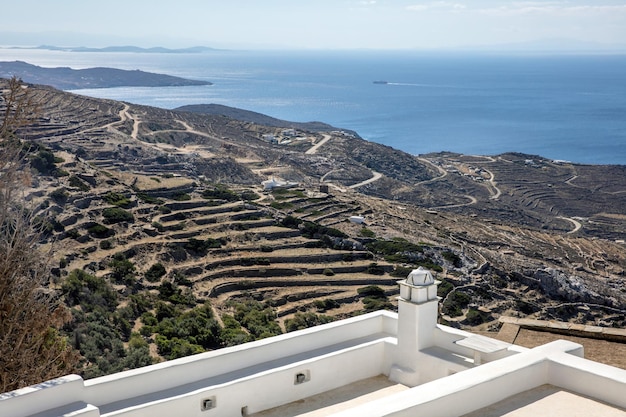 Cyclades Greece Tinos Greek island white house roof over blue sea and sky aerial view