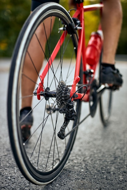 Cycling competition unrecognizable male cyclist athletes riding a race on road focus on bicycle crop...