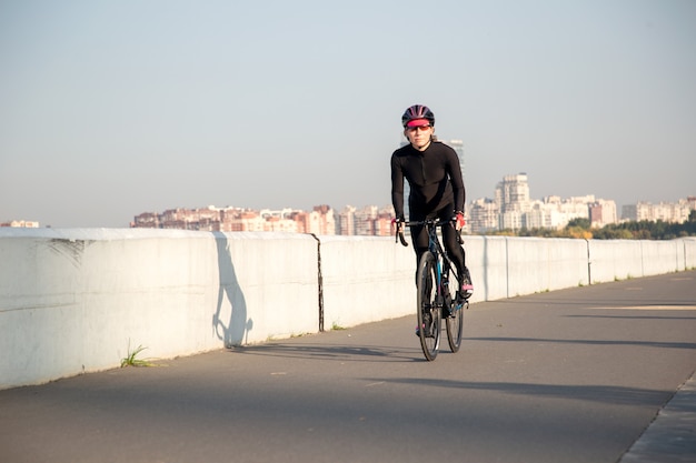 Cycling in sunny weather along a city street