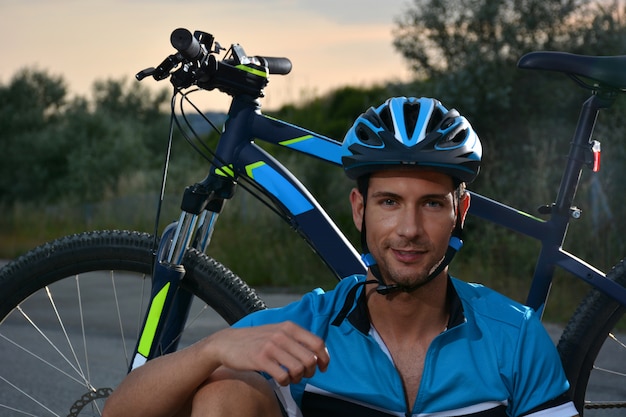 Cyclist going mountain bike along a lonely road 