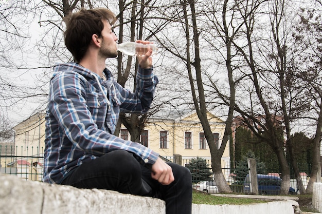 Cyclist quenches the thirst of drinking water