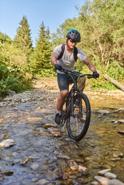 A cyclist rides a bike on extreme and dangerous forest roads Selective focus