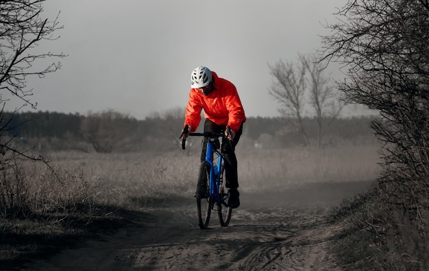 Cyclist rides gravel bicycle along on a trail Extreme sports and activity concept