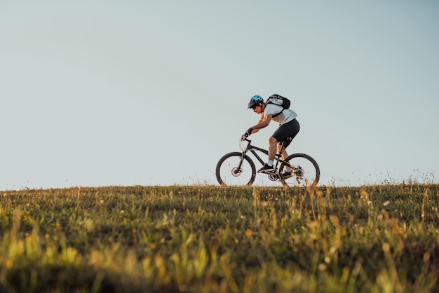 Cyclist Riding the Bike on the Trail in the Forest Man cycling on enduro trail track Sport fitness motivation and inspiration Extreme Sport Concept Selective focus Highquality photo