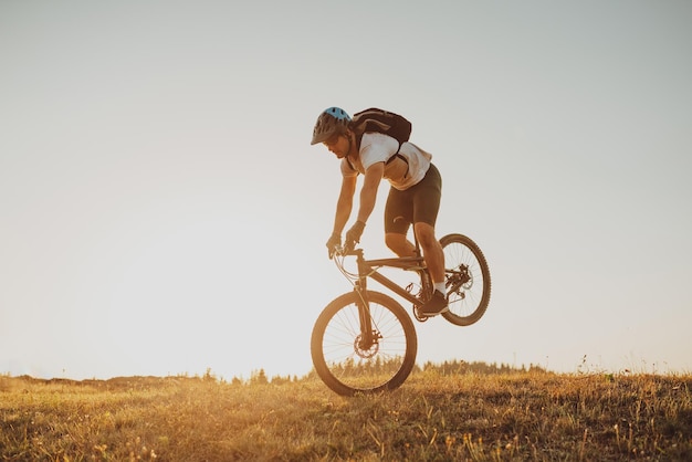 Cyclist Riding the Bike on the Trail in the Forest Man cycling on enduro trail track Sport fitness motivation and inspiration Extreme Sport Concept Selective focus Highquality photo