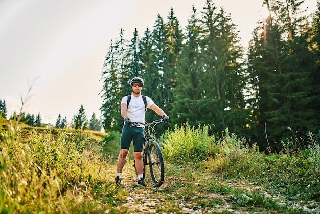 Cyclist Riding the Bike on the Trail in the Forest Man cycling on enduro trail track Sport fitness motivation and inspiration Extreme Sport Concept Selective focus