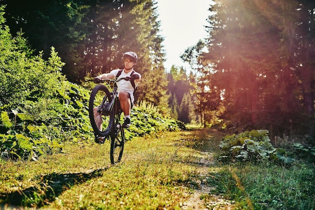 Cyclist Riding the Bike on the Trail in the Forest Man cycling on enduro trail track Sport fitness motivation and inspiration Extreme Sport Concept Selective focus