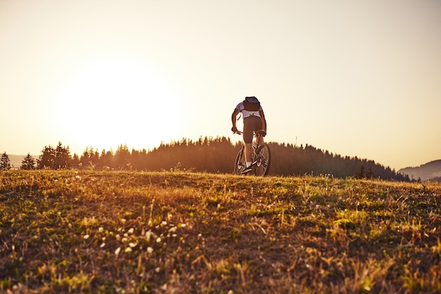 Cyclist Riding the Bike on the Trail in the Forest Man cycling on enduro trail track Sport fitness motivation and inspiration Extreme Sport Concept Selective focus